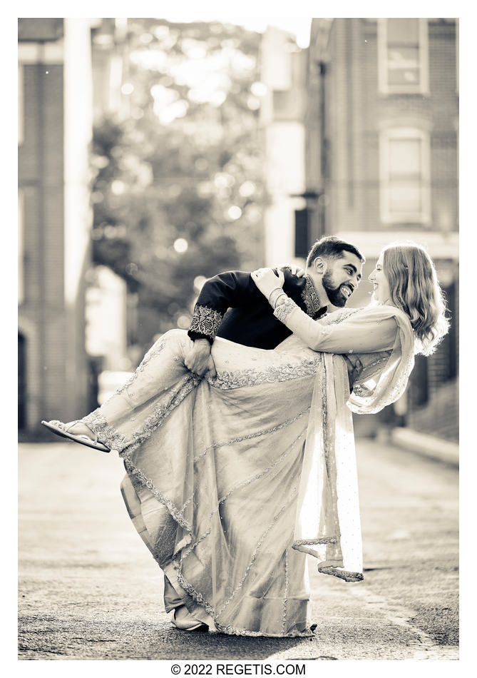 A black and white photograph of the engaged couple doing their happy dance.
