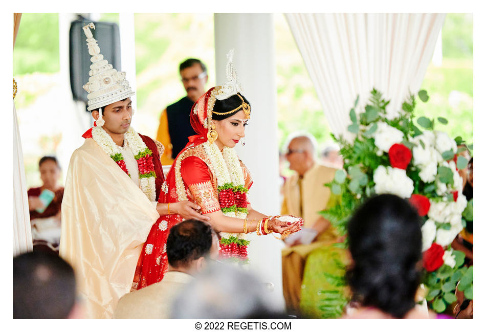 Bride and groom offering puffed rice to the God of Fire, Agni as part of their Hindu Wedding Rituals