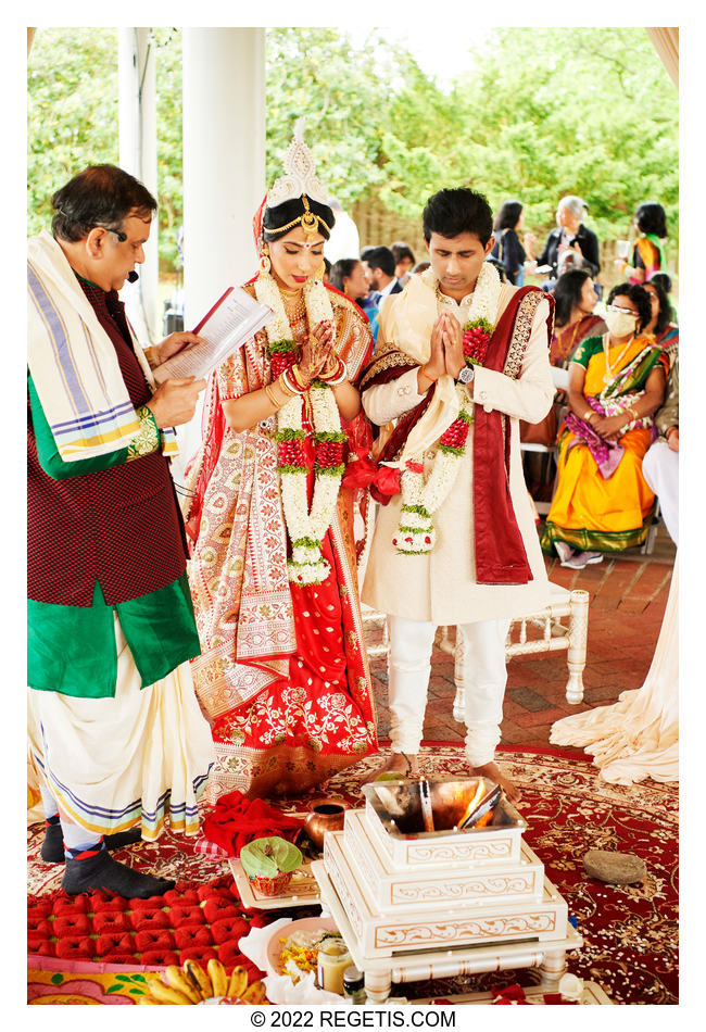 Bride and Groom receiving blessings from the priest at their south asian wedding.