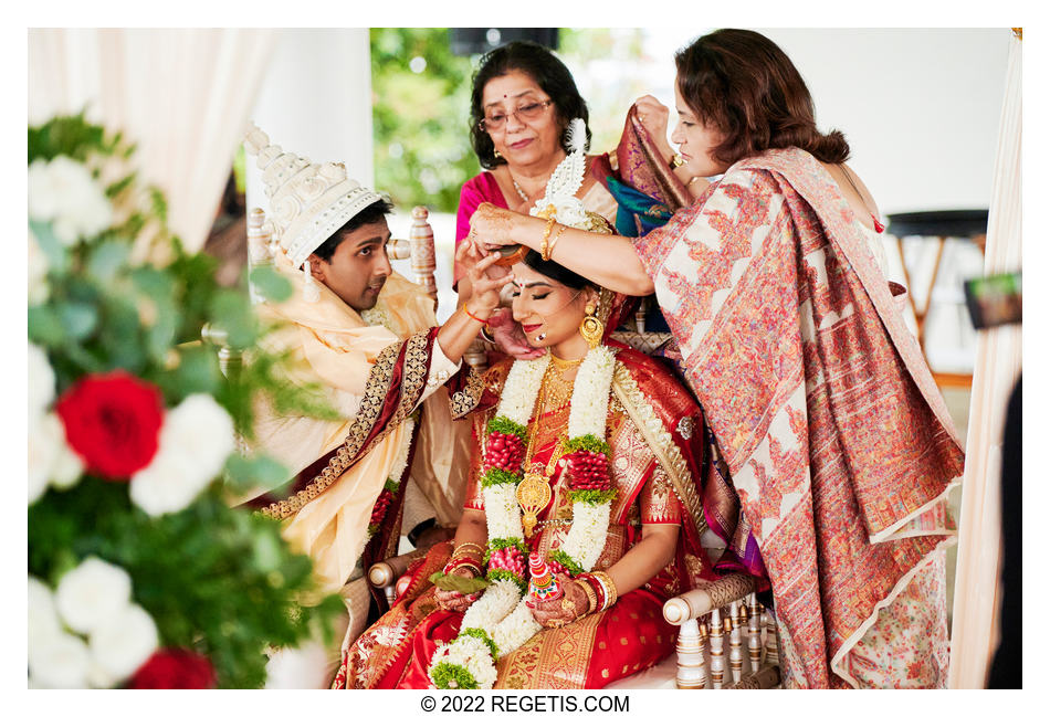 Groom putting sindoor, kumkum in bride’s hair as a Hindu Wedding Ritual