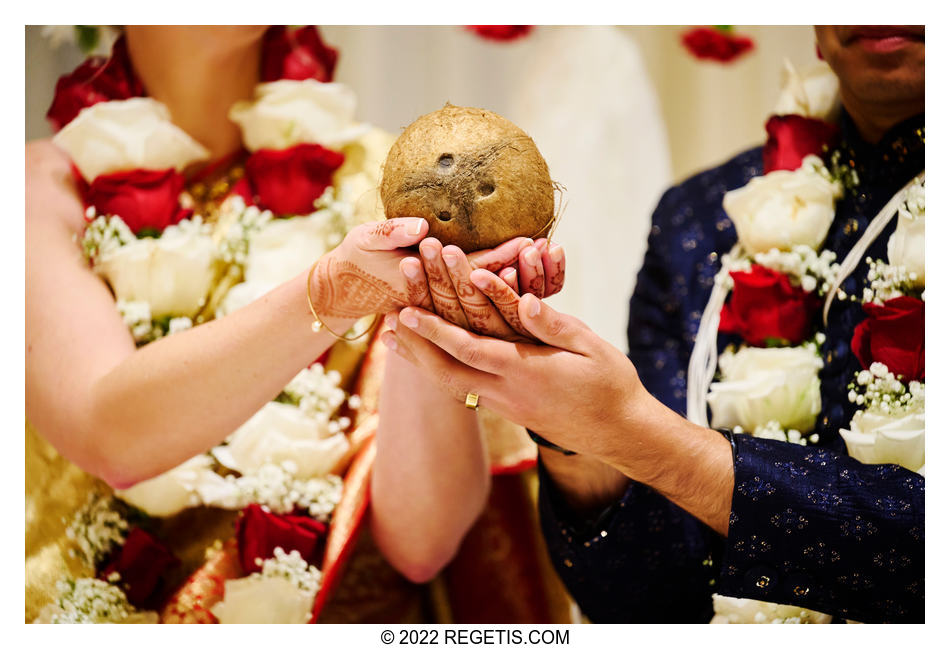 Bride and Groom holding a coconut