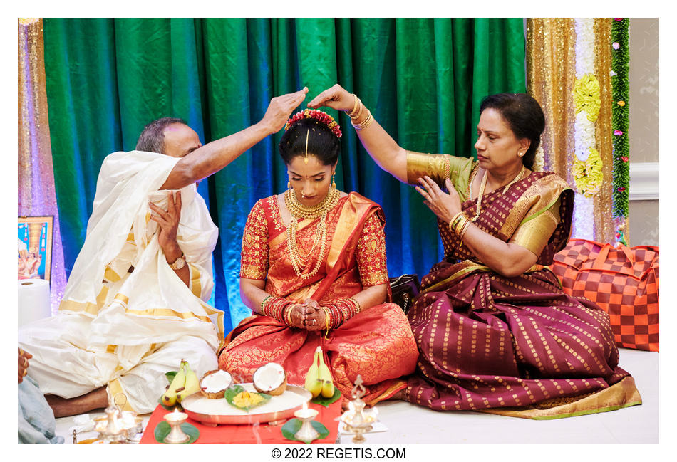 Mother and father blessing their daughter at Gowri pooja