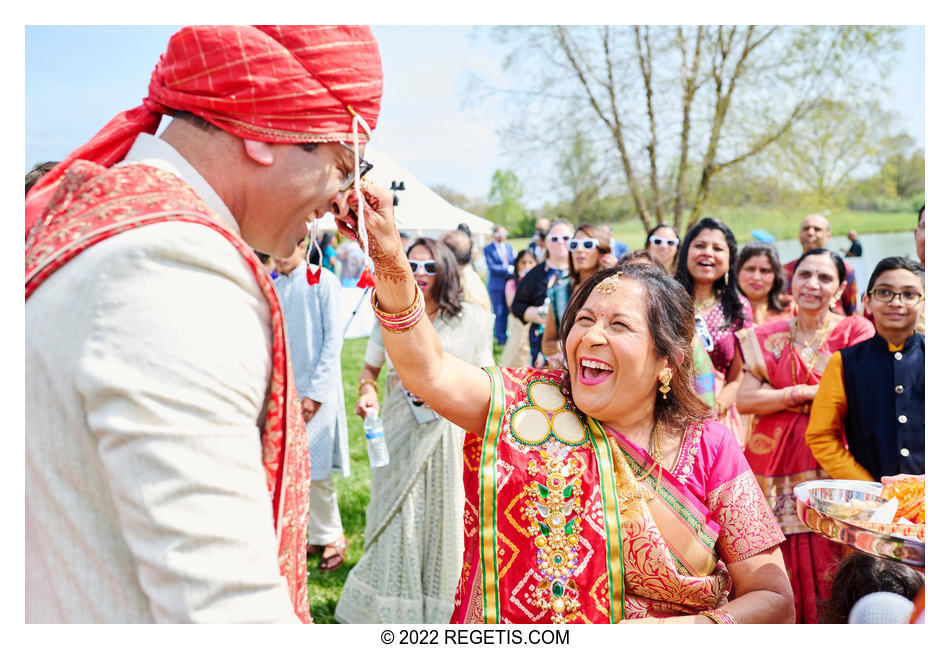 Mother of the bride pinching the groom’s nose a tradition at Indian Weddings