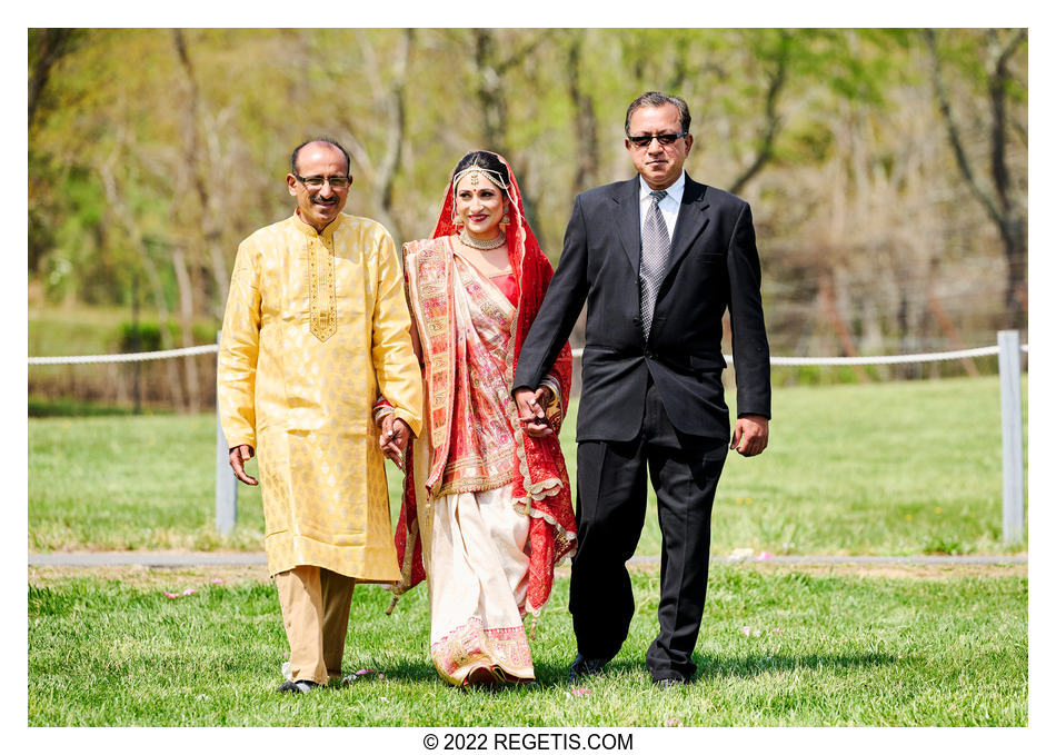 Hindu Bride walking down the isle with her uncles.