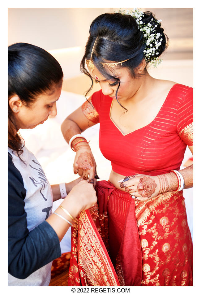 Tripali is getting ready in her red wedding saree for her Indian Hindu ceremony. Sagina Wahi, the wedding planner, is helping.