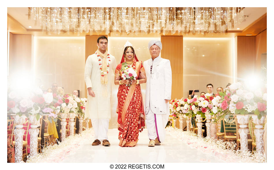 Brother and Father of the bride walk her down the isle at her Hindu  South Asian Wedding at the Conrad Hotel Washington